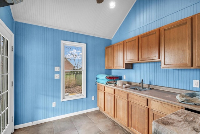 1709 Brighton Ct, Champaign, IL 61822 - kitchen with lofted ceiling, a sink, baseboards, light countertops, and ornamental molding