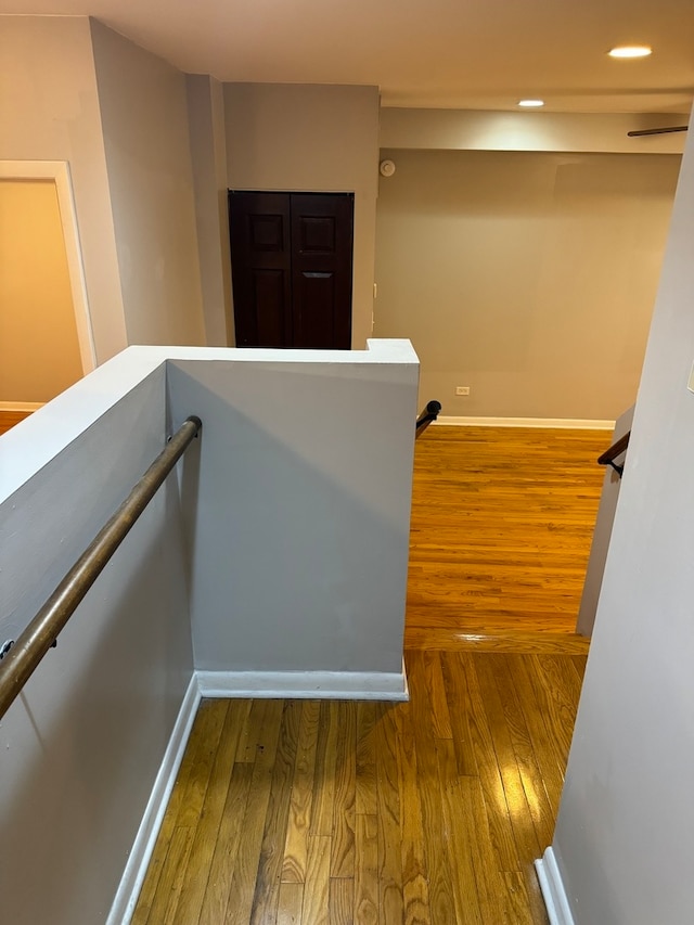 staircase with wood-type flooring