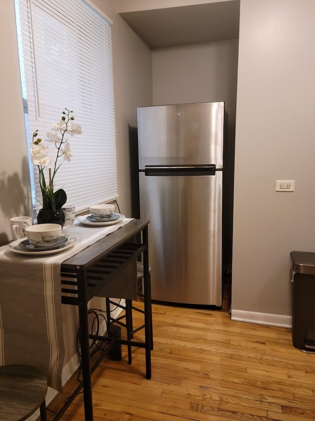 kitchen featuring light hardwood / wood-style flooring and stainless steel refrigerator