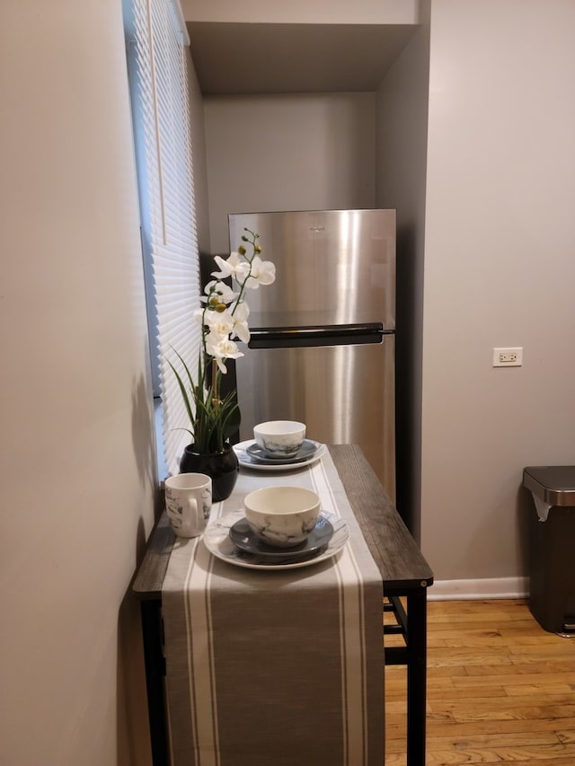 kitchen featuring light hardwood / wood-style flooring and stainless steel refrigerator