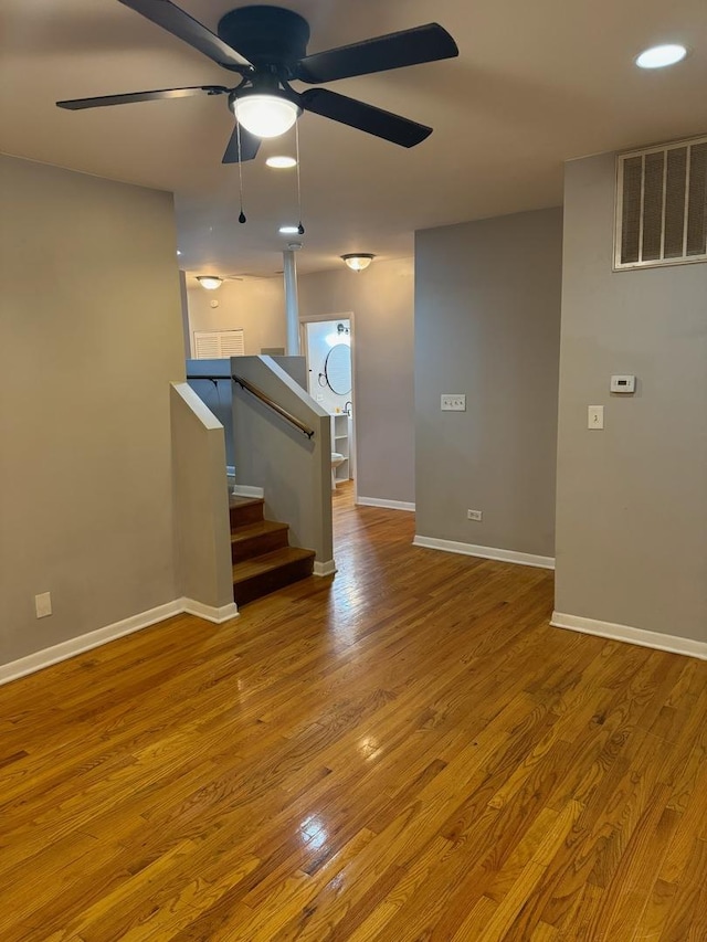 unfurnished living room with ceiling fan and light wood-type flooring