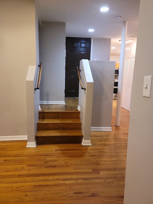 stairs featuring wood-type flooring