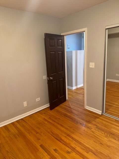 unfurnished bedroom with a closet and light hardwood / wood-style flooring