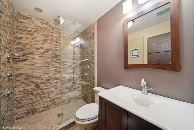 bathroom with vanity, toilet, and an enclosed shower