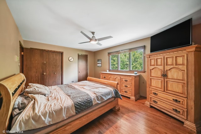 bedroom with light hardwood / wood-style floors and ceiling fan