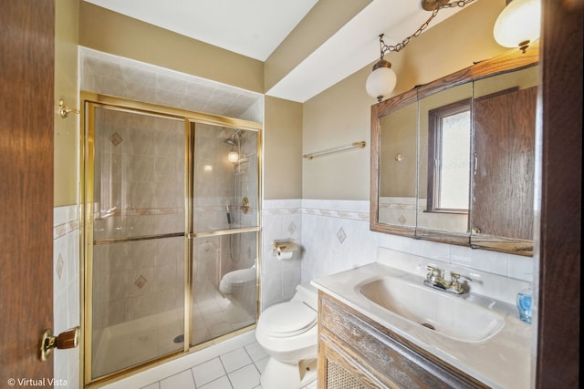 bathroom featuring walk in shower, tile walls, and toilet