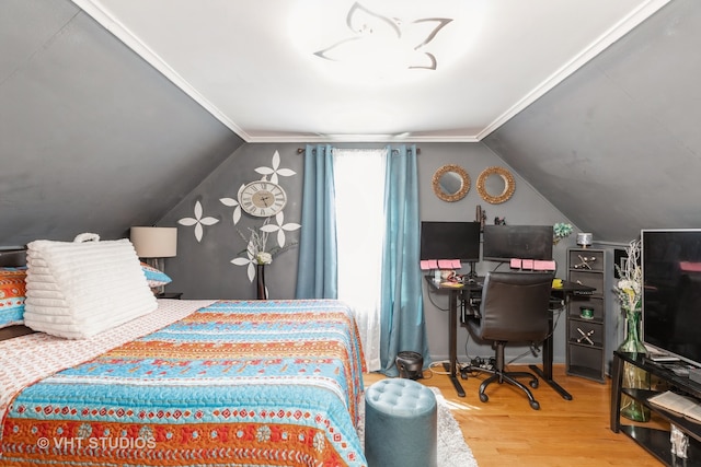 bedroom featuring wood-type flooring, lofted ceiling, and crown molding