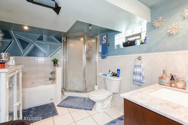 full bathroom featuring tile walls, vanity, separate shower and tub, toilet, and tile patterned floors