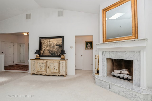 living room with a fireplace, light carpet, and high vaulted ceiling