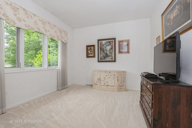 sitting room with light colored carpet and baseboards