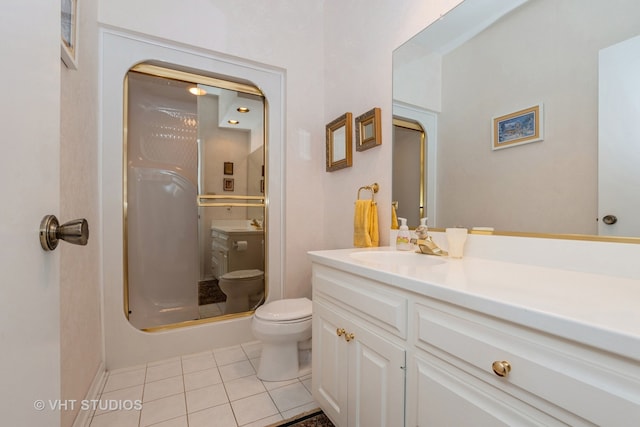 bathroom featuring walk in shower, vanity, toilet, and tile patterned floors