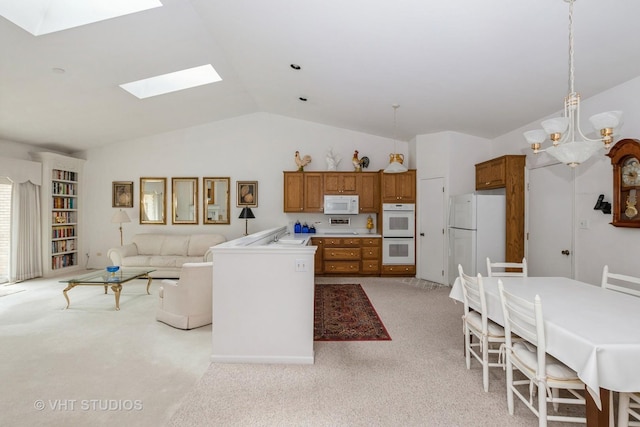 kitchen with open floor plan, white appliances, lofted ceiling with skylight, light carpet, and brown cabinetry