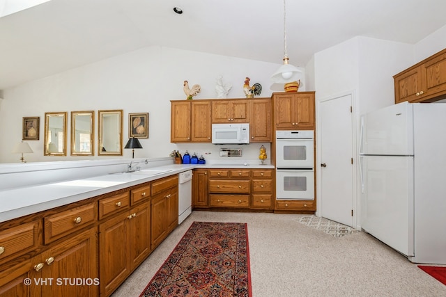 kitchen featuring light carpet, white appliances, vaulted ceiling, and hanging light fixtures