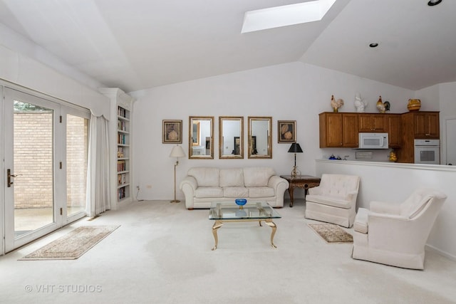 living room with light carpet and vaulted ceiling with skylight