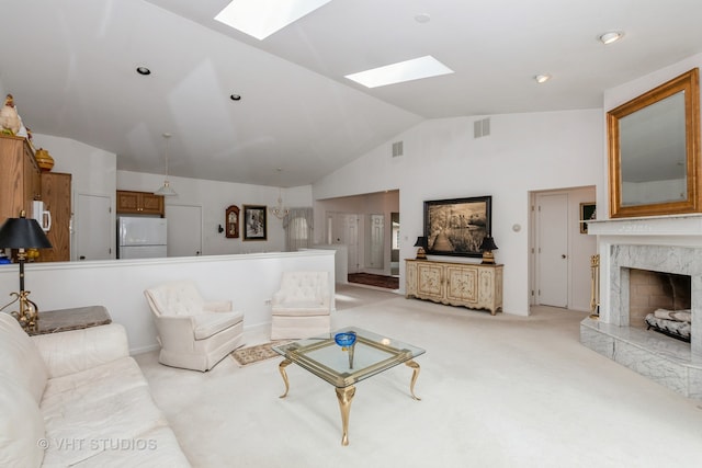 living room with light carpet, vaulted ceiling with skylight, and a premium fireplace