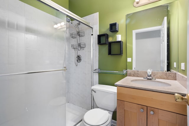 bathroom with walk in shower, vanity, and toilet