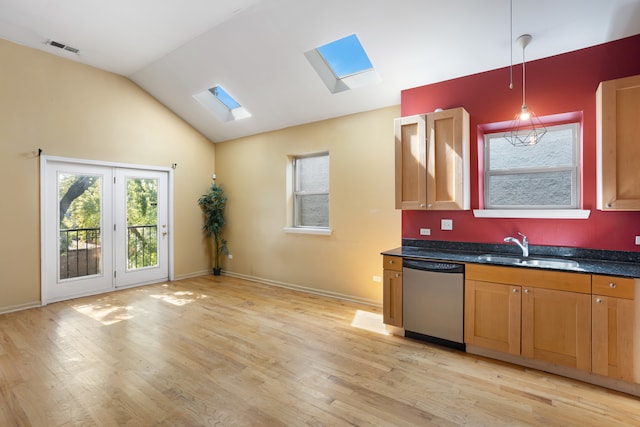 kitchen featuring light wood-type flooring, sink, hanging light fixtures, lofted ceiling with skylight, and stainless steel dishwasher