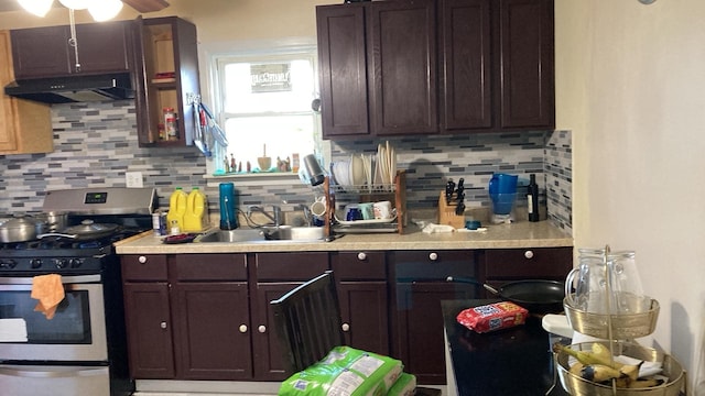 kitchen featuring backsplash, exhaust hood, ceiling fan, dark brown cabinetry, and stainless steel gas stove