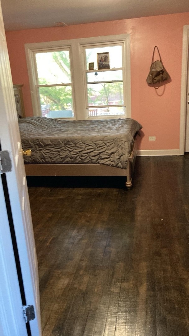 unfurnished bedroom with dark hardwood / wood-style floors