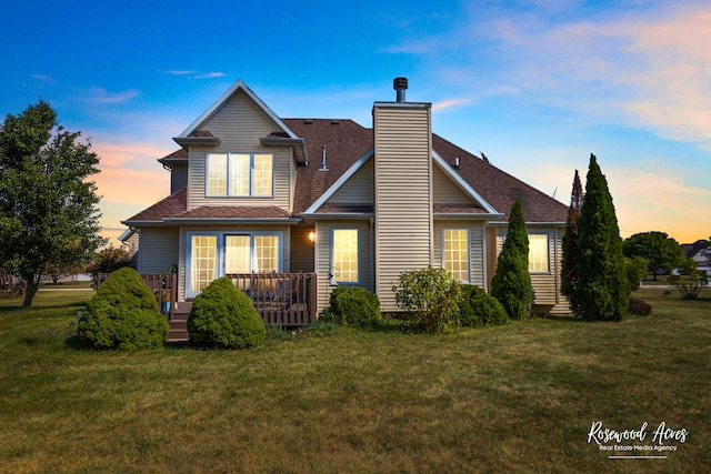 exterior space with a wooden deck and a lawn