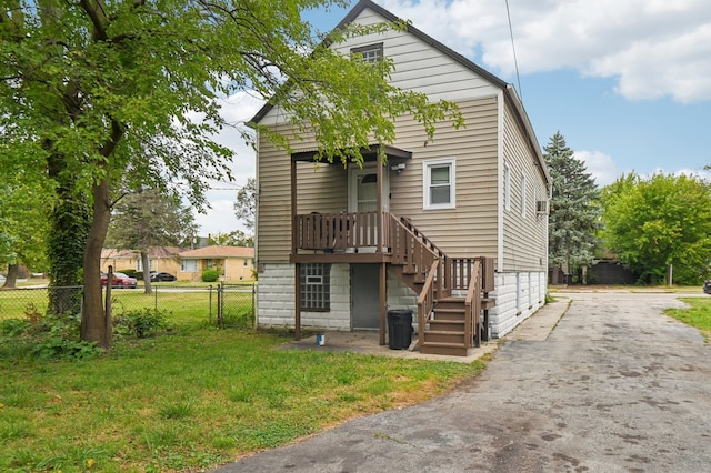 back of house with a lawn