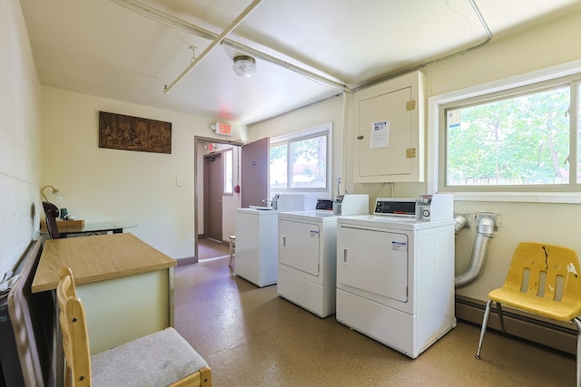 laundry room with separate washer and dryer and a baseboard radiator