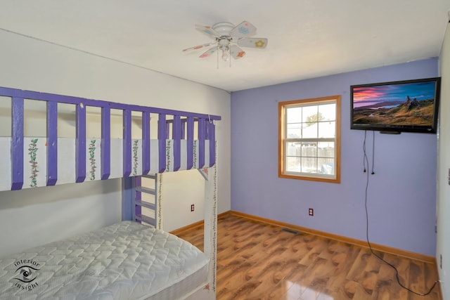 bedroom with ceiling fan and hardwood / wood-style floors