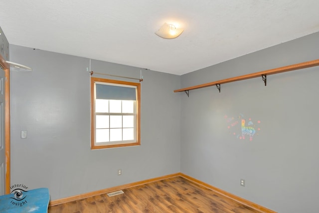 unfurnished room featuring hardwood / wood-style flooring