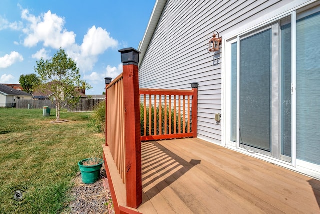 wooden deck featuring a yard