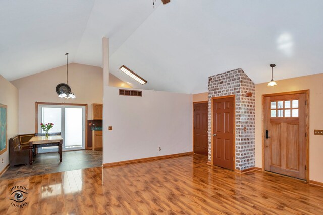 foyer entrance with lofted ceiling and hardwood / wood-style floors