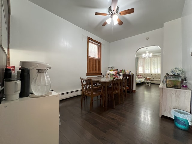 dining space with a baseboard radiator, ceiling fan with notable chandelier, dark wood-type flooring, and a healthy amount of sunlight