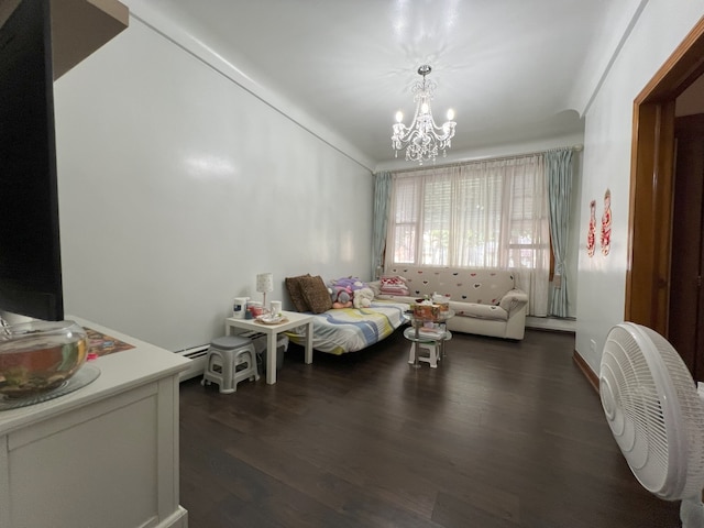 living room featuring an inviting chandelier and dark hardwood / wood-style flooring