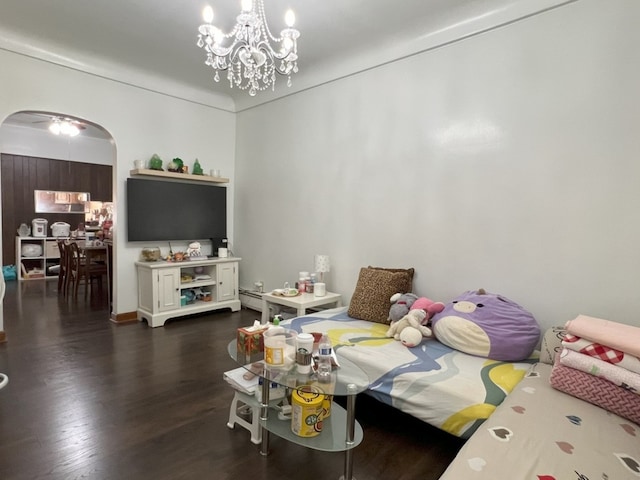 living room with a baseboard radiator, dark wood-type flooring, and a notable chandelier