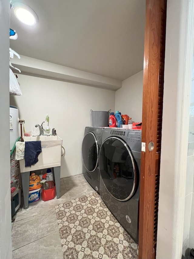 washroom with gas water heater and independent washer and dryer