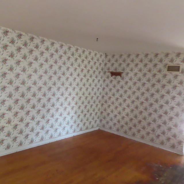 empty room with hardwood / wood-style floors