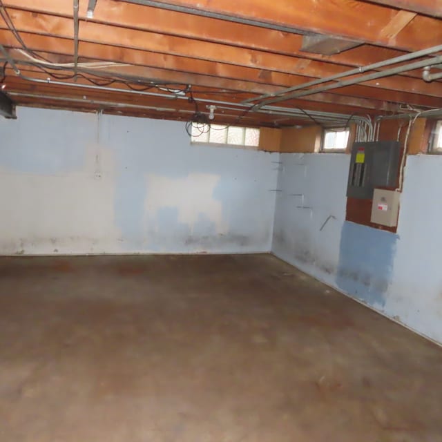 basement featuring electric panel and plenty of natural light