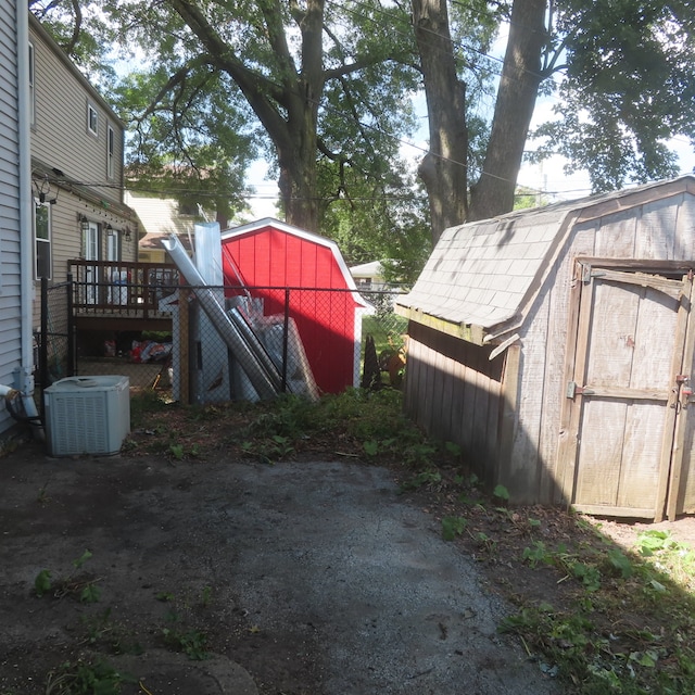 view of yard with a shed and central air condition unit