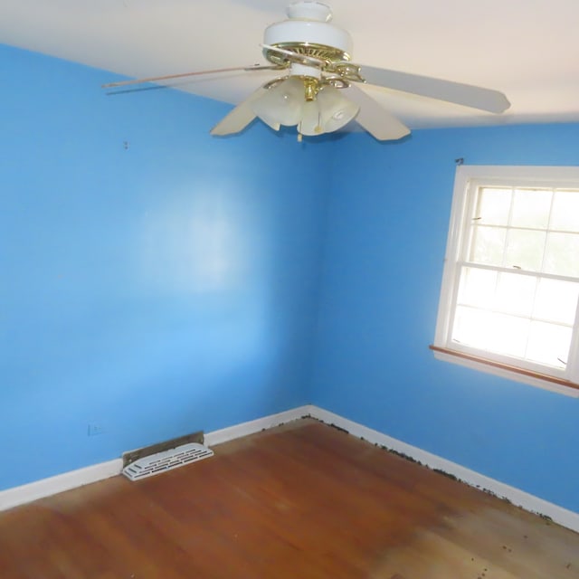 unfurnished room with ceiling fan and hardwood / wood-style flooring