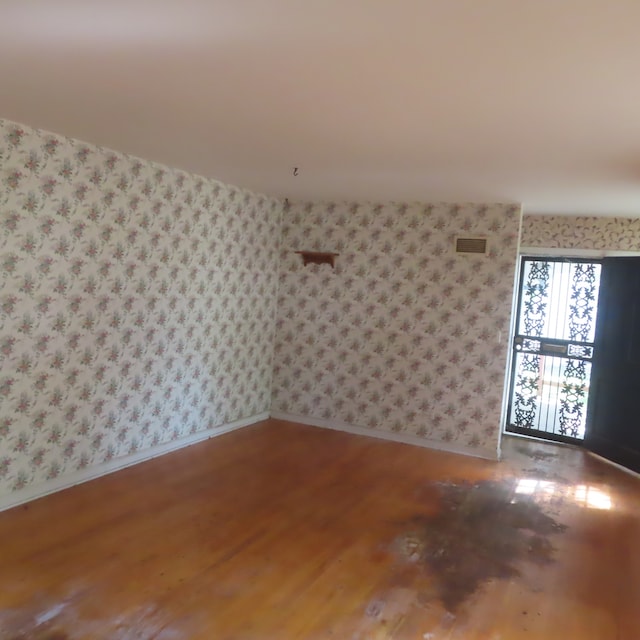 unfurnished room featuring hardwood / wood-style flooring