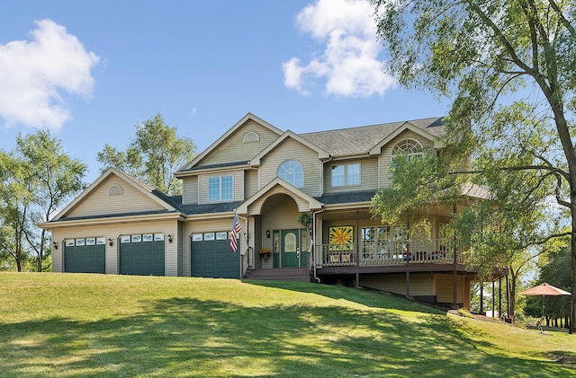 view of front facade with a front lawn, covered porch, and a garage