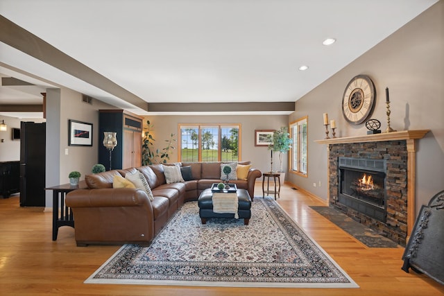 living room with a fireplace and light hardwood / wood-style flooring