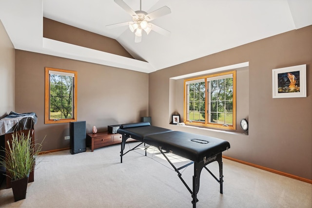 recreation room with ceiling fan, light colored carpet, a healthy amount of sunlight, and lofted ceiling