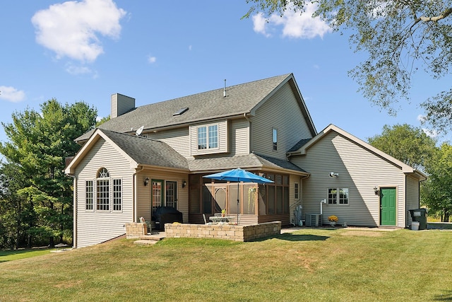 rear view of property with a lawn