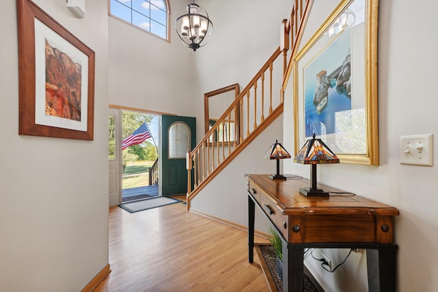 foyer entrance featuring light hardwood / wood-style flooring and a chandelier