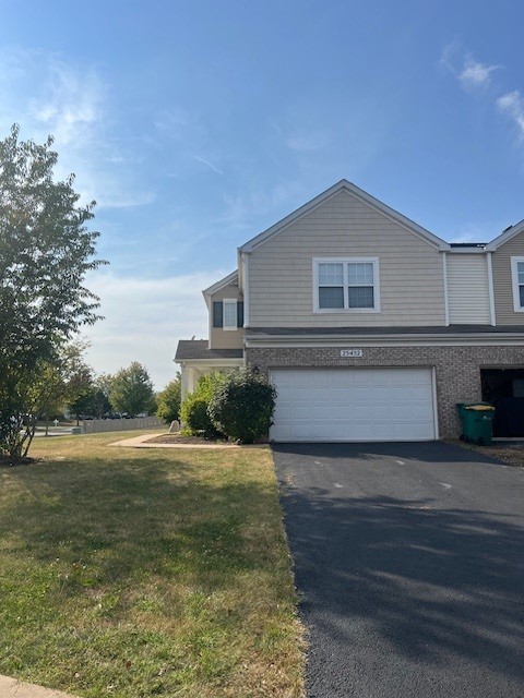 view of front of property with driveway, a front lawn, and a garage