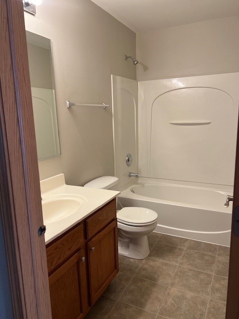 bathroom featuring toilet, tub / shower combination, and vanity