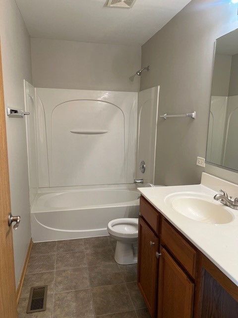 full bathroom featuring vanity, toilet,  shower combination, and visible vents