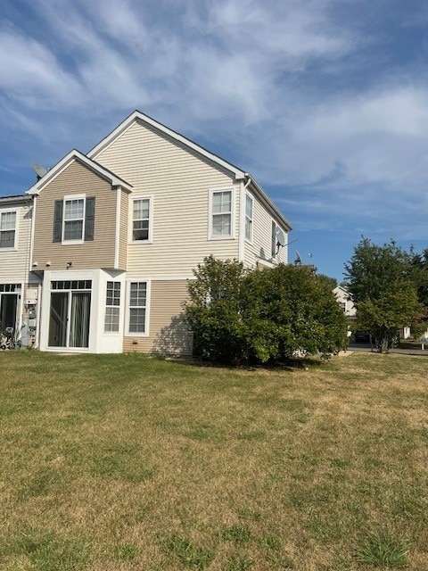 rear view of property with a yard