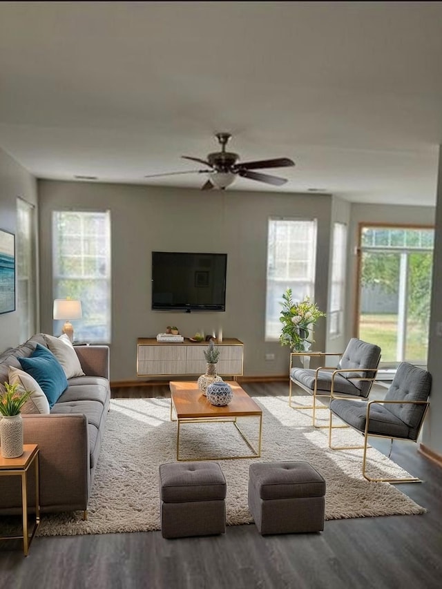 living area featuring ceiling fan, wood finished floors, and a wealth of natural light