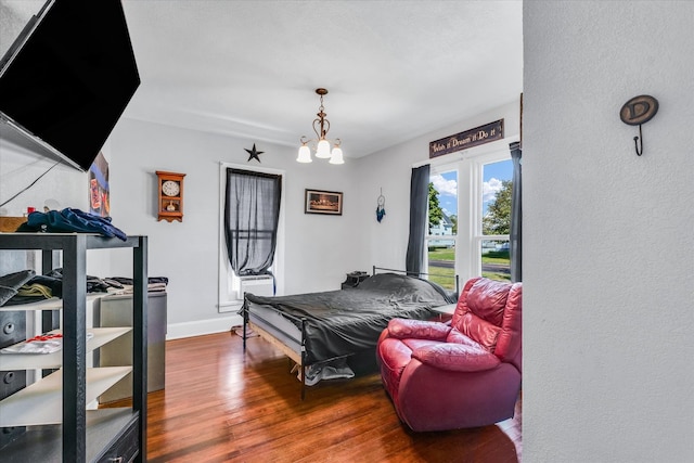 living room with an inviting chandelier and wood-type flooring